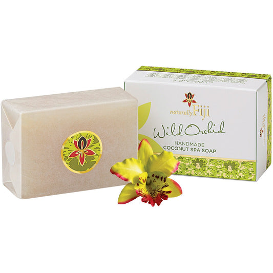 A bar of natural Fiji Wild Orchid Handmade Coconut Spa Soap shown next to its white and green packaging box, with a yellow and red orchid flower in the foreground on a white background.