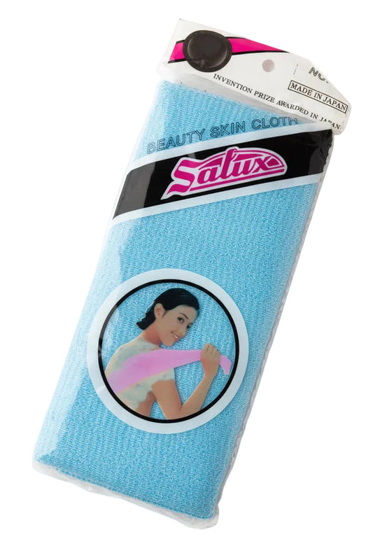 A packaged blue Satuse Beauty Skin Glove on a wooden tabletop. The product is in its original plastic packaging with a cardboard header and a circular graphic label showing a woman holding the glove.